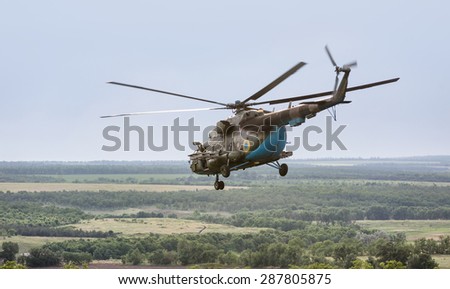 DONETSK REG, UKRAINE - Jun 11, 2015: Ukrainian military helicopter in flight on combat duty in the area of the antiterrorist operation