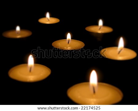 Small candles isolated on black background