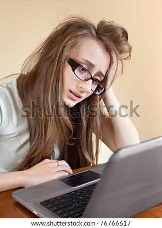 Young woman in glasses frustrated on the computer