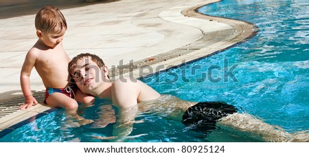 Little boy and his father in the pool