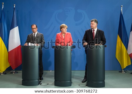 BERLIN, GERMANY - Aug 24, 2015: French President Francois Hollande, Chancellor of Federal Republic of Germany Angela Merkel and President of Ukraine Petro Poroshenko during a joint briefing in Berlin