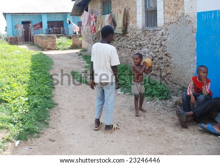 WASSINI ISLAND, KENYA, AFRICA, DECEMBER 2008: Little African children play football in a poor fishermen\'s village during visit of a humanitarian group.