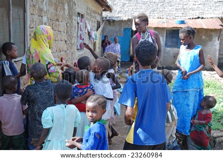 WASSINI ISLAND, KENYA, AFRICA, DECEMBER 2008: African children in a poor fishermen's village getting candies during visit of a humanitarian group.