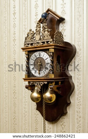 old antique wood clock with carvings for metal hanging on the wall