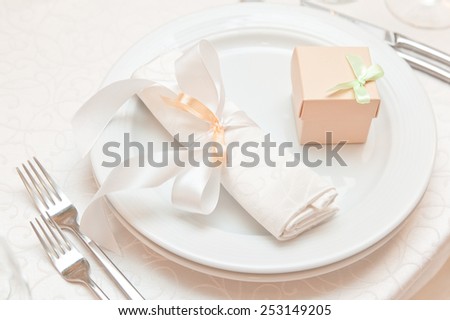 wedding table appointments closeup with gift box. table setting