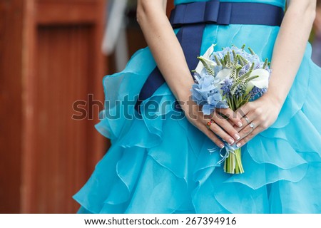 Beautiful wedding bouquet of hydrangea, calla and muscari flowers in hands of the bride