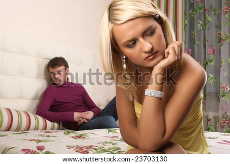 young beautiful woman and man argue in bedroom