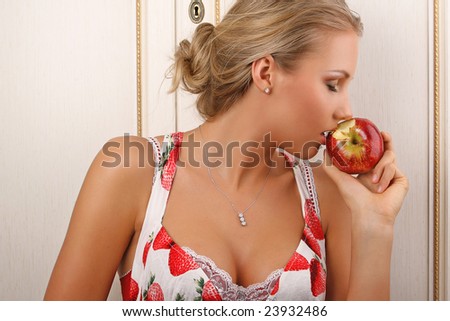 young attractive female holding and kissing an red apple