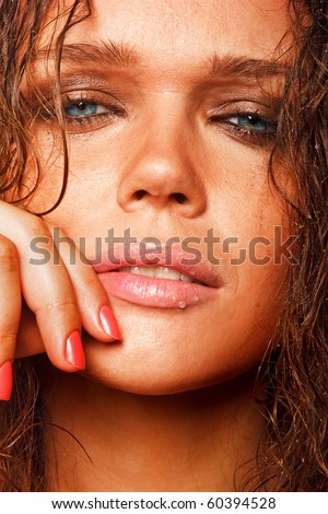 closeup portrait of beautiful wet woman with sun tan looking at camera
