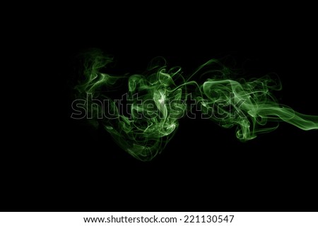 Green smoke trail on black background