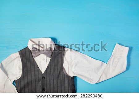 white shirt, gray vest and a bow tie on a bright blue background, the concept of the festival, celebrations, ceremonies happy Father\'s Day, Happy Birthday Dad
