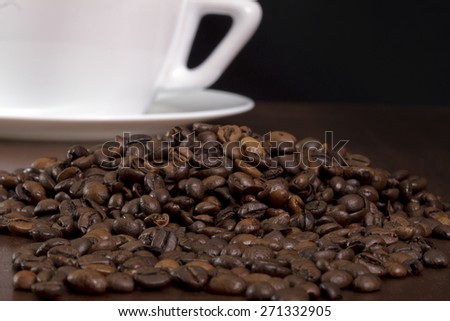Coffee crops texture and coffee cup and plate on a black background