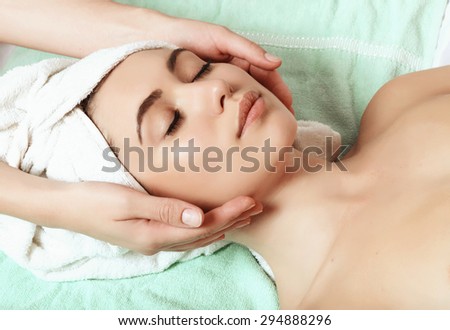 beautiful and young girl doing anti-aging facial massage