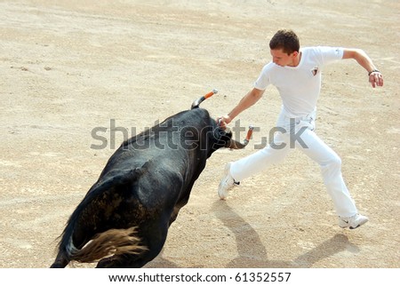 ARLES - JULY 9: Trainees of the school for Raseteur in Arles Florian Rado fights against a Camargue-bull in the arena on July 09, 2010 in Arles, Bouche du Rhone, Fance