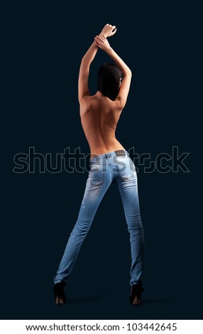 woman in jeans on a black background