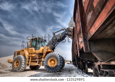 Wheel loader excavator with backhoe unloading clay Wheel loader excavator with backhoe unloading clay