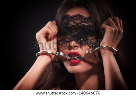 girl in a black mask and handcuffed