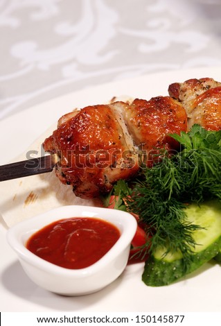 Tasty meat in a dish with sauce and vegetables