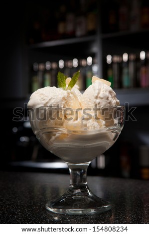 a glass of ice-cream stands on the bar
