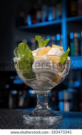 a glass of ice-cream stands on the bar