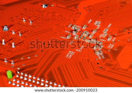 A orange circuit board, solderings and paths