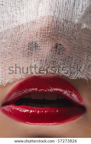 young woman\'s face covered by a veil