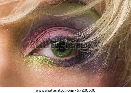 eye women beautiful green color on the background of blond hair