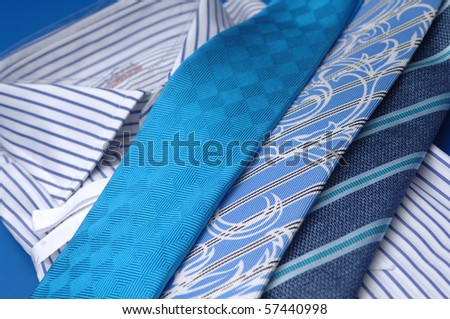 ties of different colors lie on a shirt