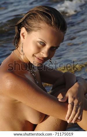 stock photo beautiful naked woman sitting on the beach