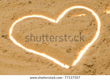 White contour heart in the sand. Horizontal composition.