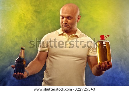 happy man with lots of beer in confusion on a colored background
