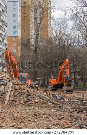 crawler excavator removes construction waste after building demolition