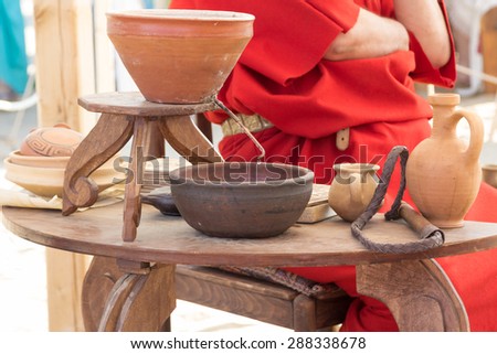 ancient Roman clay moonshine and utensils on the table