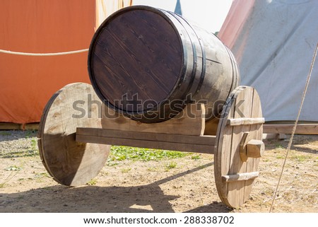 ancient wooden cart with a wooden barrel