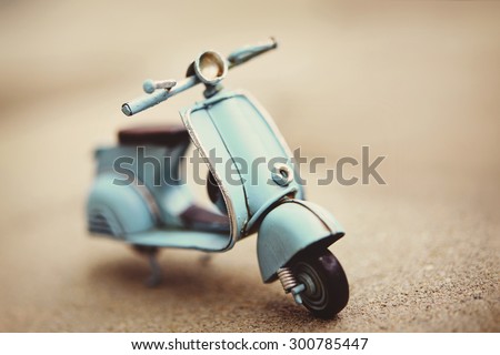 Small retro scooter toy, toned sepia