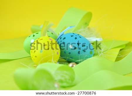 Colorful, beautifully crafted Easter eggs on green decoration