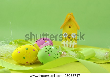 Easter decoration with colorful Easter eggs and a wooden house