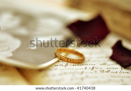 stock photo Old wedding ring on an old diary and vintage photo