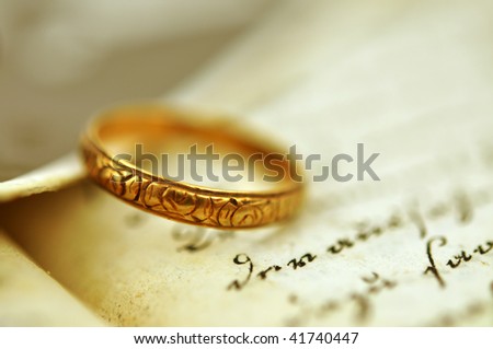 stock photo Old wedding ring on an old diary and vintage photo