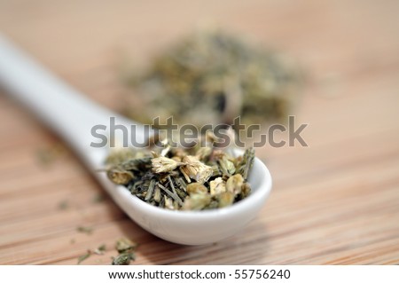 Yarrow herbal tea with the white spoon