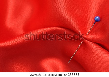 Straight pin in a red satin