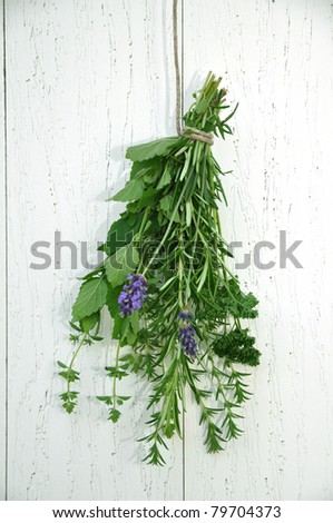 Bunch of fresh herbs, hanging on a rope to dry