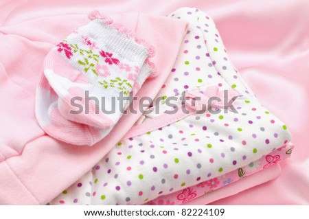 Pile of pink baby clothes