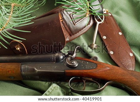 Old hunting rifle with a belt and a knife