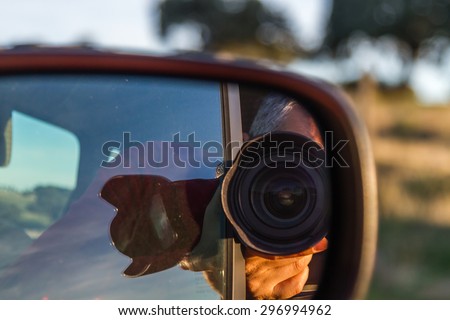 self-portrait of a photographer in a mirror of a car day