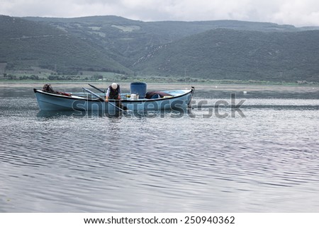 Bursa, Turkey - May 10, 2014: Fisherman are collecting their nets on Ulubat Lake, Bursa, Turkey.
