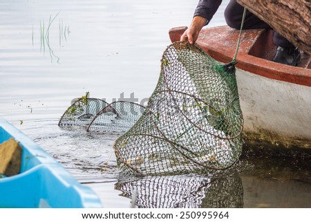 Bursa, Turkey - May 10, 2014: Fisherman are collecting their nets on Ulubat Lake, Bursa, Turkey.
