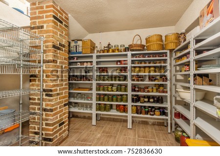 Home food storage room. Various jars with Home Canning Fruits and Vegetables jam on shelves