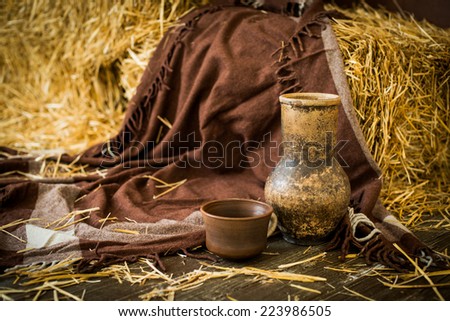 clay rustic dishes on straw background
