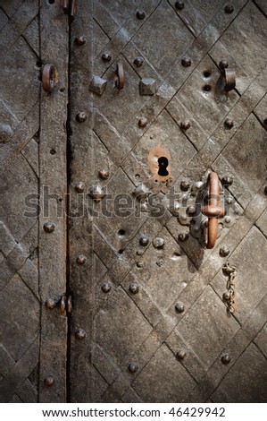 fragment of the old wrought bronze doors of the palace with a handle and lock